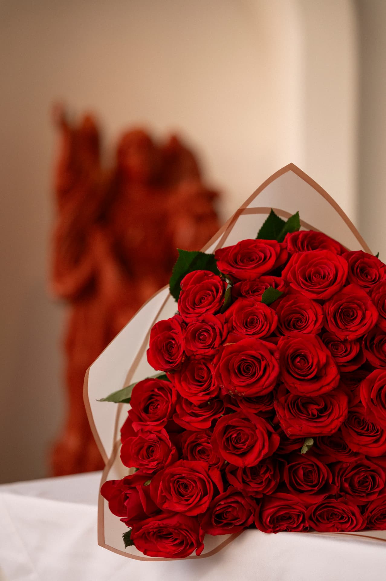 Private proposal dinner table for two with a red roses bouquet on a terrace overlooking the bay of Puerto Vallarta